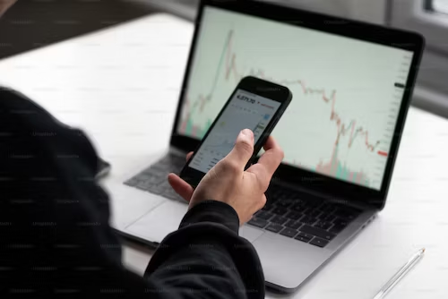 What is Trading and Its Potential Benefits? 1 a person holding a phone