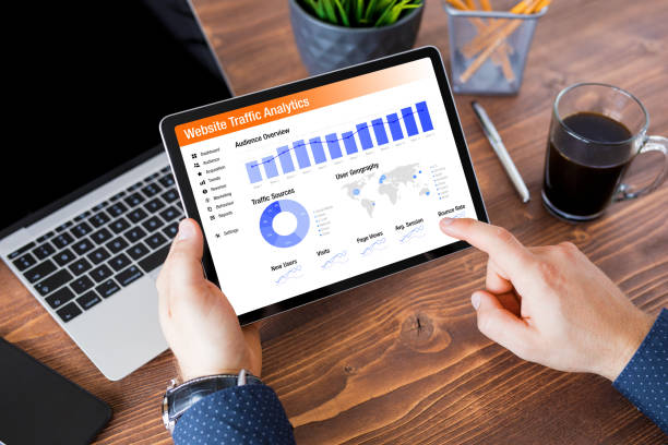 10 Amazing Benefits Of Using Guest Post Services 3 Man viewing website traffic analytics data on tablet computer