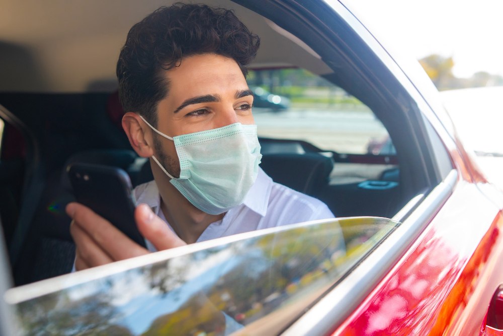 What Medical Assessments Are Part of Bus Driver Training? 2 Portrait of driver wearing face mask and using his mobile phone on way to work in a car - Medical Assessments
